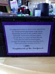 a purple and black box with a poem on it sitting on top of a wooden table