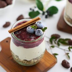 a dessert in a jar with blueberries and granola