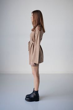 Mini wrap dress in merino wool with tie around waist and subtle bell sleeve. Fall Beige Dress With Belted Cuffs, Beige Fall Dress With Belted Cuffs, Chic Loungewear Dress With Tie Waist, Elegant Dresses With Tie Waist For Loungewear, Luxury Belted Mini Dress, Elegant V-neck Belted Mini Dress, Chic Belted V-neck Mini Dress, Luxury Wool Single-breasted Blazer Dress, Luxury V-neck Belted Mini Dress