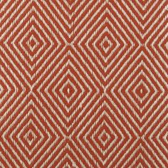 an orange and white diamond pattern on fabric