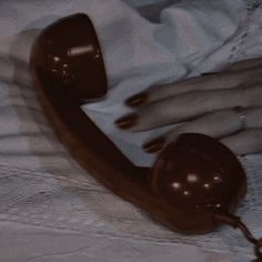 an old fashioned telephone sitting on top of a bed