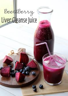 beet berry liver cleanse juice in a glass next to sliced beets and blueberries