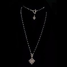 The Pilgrims Cross in Hematite and Silver Necklace is made with Bicone Hematite Crystals and designed long enough to be double wrapped. A small Fleur de Lis graces the toggle clasp so it can be worn in the front when doubled. The Jerusalem Pilgrim Cross on this necklace is stunning and can be worn day or night. The Pilgrims Cross is also known as the Jerusalem Cross. It is a heraldic cross and dates back to the 1280 or earlier. There are variants to the design, with either the four crosslets als The Pilgrims, Dove Necklace, Hematite Crystal, Lapis Lazuli Necklace, Wrap Necklaces, White Turquoise, Sterling Silver Cross, Silver Cross, Toggle Clasp