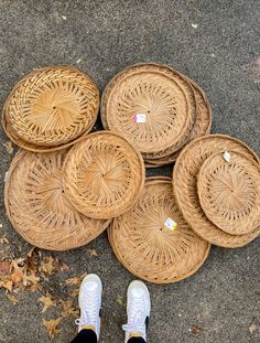 a person standing next to some baskets on the ground