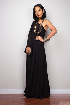 "Black one shoulder dress, Long black kaftan dress, Off shoulder evening dress, black cocktail dress, black party dress, reversible dress PRODUCT SIZE : Free Size * Chest : 40\" will stretch to 44\" * Waist : 40\" will stretch to 44\" * Hips : 40\" will stretch to 44\" * Sleeve length : 23\" * Length : 57\" - 58\" from shoulder to hem (measured when laying flat) MATERIAL : * ITY (polyester jersey) > soft and comfortable to wear, not as slippery as spandex. NOTE : * Model chest : 32\", waist : Bohemian One Shoulder Evening Dress, Bohemian One-shoulder Evening Dress, Bohemian Off-shoulder Evening Dress, One-sleeve Evening Maxi Dress, Black One-shoulder Asymmetrical Dress For Gala, Elegant One-sleeve Evening Maxi Dress, Black One-shoulder Floor-length Party Dress, Black One Shoulder Floor-length Party Dress, Black Floor-length One Shoulder Party Dress