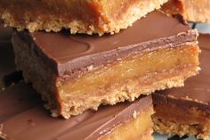 several pieces of chocolate peanut butter bars stacked on top of each other