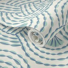 an abstract blue and white wallpaper with wavy lines on it's surface, as well as a roll of paper