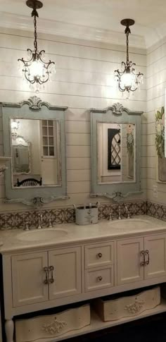 a bathroom with two sinks and three mirrors