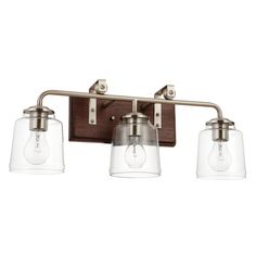 three light bathroom fixture with clear glass shades on the bulbs and wood frame, in an antique