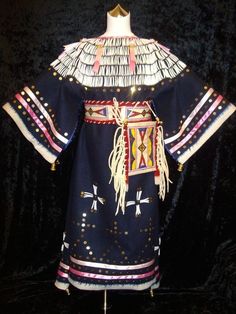 an elaborately designed dress with feathers on it