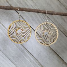 Looking for the perfect pair of earrings to ride the waves of style? Look no further than these Big Wave Wooden Circle Dangle Earrings, handcrafted with love and care by our skilled artisans. Made from lightweight, nickel-free materials, these earrings are gentle on even the most sensitive skin. Whether you're a lover of Art Nouveau or simply appreciate a stunning sunset, these earrings will have you feeling like the queen of the sea. The intricate wave design captures the essence of the ocean, making these earrings a must-have for any ocean enthusiast. Pair these earrings with your favorite sundress and sandals for a beachy, bohemian vibe, or dress them up with a sleek jumpsuit and heels for a night out. Whatever your style, these Big Wave Wooden Circle Dangle Earrings are sure to make a Roaring 20s Style, Roaring 20s Jewelry, Roaring 20s Fashion, 20s Style, Aluminum Earrings, Wooden Circle, Ocean Jewelry, By The Ocean, Eco Friendly Jewelry