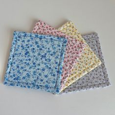 four different colors of fabric on a white surface