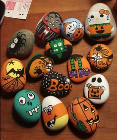 painted rocks with cartoon characters and pumpkins on them