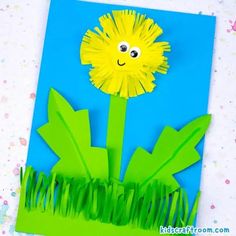 a paper cut out of grass with a flower on it and the words dandelion in