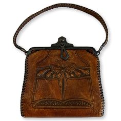 "Antique hand-tooled leather Bosca Nelson Edwardian handbag. made circa 1920s. Bosca was an Italian American immigrant whose handbags are of the highest workmanship and quality. Art Deco styling with butterfly and flowers. Clasp is in good working condition and interior is clean. Maker's tag inside. 10\" bottom to top; 6\" Wide." Vintage Embossed Satchel For Everyday Use, Vintage Embossed Leather Shoulder Bag, Vintage Leather Embossed Shoulder Bag, Vintage Embossed Satchel Bag, Vintage Leather Shoulder Bag With Embossed Details, Vintage Brown Hand Tooled Bag, Vintage Hand Tooled Satchel For Daily Use, Vintage Embossed Leather Bags, Hand Tooled Vintage Brown Satchel