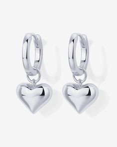 Description:Make a bold fashion statement with our stunning heart huggie earrings, perfect for adding a touch of romance to your everyday look. Small but mighty, featuring a charming heart charm, they're ideal for any occasion, from a Valentine's Day date to a cozy evening.Materials: 14K Yellow Gold or Rhodium plated. Sterling silver posts. Heart charm dimensions: 8.4mm x 10mm. Hoop diameter: 12mm Hypoallergenic, nickel free, and lead-free. Trendy Heart Charm Earrings For Mother's Day, Trendy Heart Charm Earrings For Anniversary, Valentine's Day Double Heart Huggie Earrings With Heart Charm, Nickel-free Huggie Earrings For Valentine's Day, Valentine's Day Heart Charm Dangle Huggie Earrings, Valentine's Day Dangle Huggie Earrings With Heart Charm, Valentine's Day Huggie Dangle Earrings With Heart Charm, Valentine's Day Huggie Hoop Earrings With Heart Charm, Trendy Huggie Heart Earrings For Valentine's Day