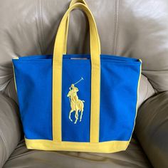 Nwot Ralph Lauren Polo Tote Bag Blue With Yellow Trim Darling! No Wear!! 12.5” X 16” X 5” Without Handles Pet And Smoke Free Home No Exchanges And No Returns Blue Canvas Shoulder Bag, Casual Yellow Bag With Top Carry Handle, Casual Yellow Bag With Top Handle, Blue Canvas Shoulder Bag With Dust Bag, Blue Canvas Travel Bag With Handles, Blue Canvas Shoulder Bag With Handles, Blue Large Capacity Bucket Canvas Bag, Yellow Canvas Shoulder Bag With Double Handle, Blue Travel Canvas Bag With Handles