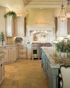 a large kitchen with white cabinets and marble counter tops