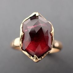 a close up of a ring with a red stone