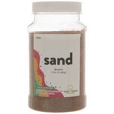 sand in a glass jar with white lid and brown ground on the bottom, labeled sand