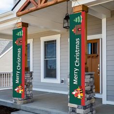 two green and red christmas banners on the front porch of a house