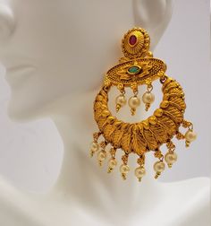 This beautiful earrings set has an excellent finish and gives out an exquisite sense of style. If you are looking for an amazing Fashion Jewelry set for special occasions such as Anniversary, Engagement, Party, Wedding, or for gifting, then your search ends here. Handmade Indian Temple Jewelry, best to wear it for traditional ceremonies or Indian wedding. This bridal jewelry has an ethnic finish. It has Cubic Zircon stones with semi-precious ruby and emeralds. It is a Bollywood style one gram je Temple Jewelry Chandbali Pearl Earrings, Pearl Chandbali Temple Jewelry Earrings, Gold Pearl Drop Earrings For Temple Jewelry, Gold Chandbali Pearl Earrings, Temple Jewelry Pearl Drop Danglers For Reception, Pearl Drop Temple Jewelry Danglers For Reception, Gold Pearl Drop Earrings For Reception, Elegant Gold Pearl Earrings For Reception, Gold Bollywood Pearl Drop Earrings