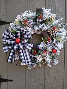 a christmas wreath hanging on the side of a door