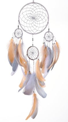 a white and orange dream catcher with feathers on it's sides, against a white background