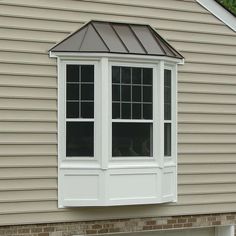 a white window on the side of a house