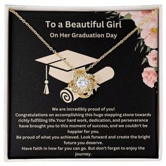 a graduation necklace with the words to a beautiful girl on her graduation day