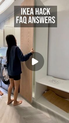 a woman standing in front of a dryer next to a washer and drying machine