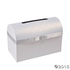 a white box with a black handle and silver foil on the lid is sitting in front of a white background