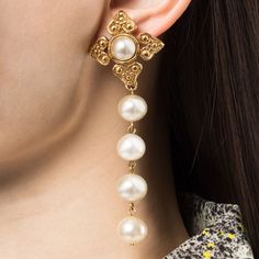 Pearls have the power to fix everything and we think these 1980s clip-on earrings do just that. Featuring a string of pearls hanging from a gold-toned pendant inspired by a Chanel signature, the maltese cross. These timeless earrings have been finished with a central pearl for maximum impact. Wear them on their own, or incorporate them into a stack for an elegant finish.Condition: Very good vintage condition. Minor signs are visible on the faux pearls. Timeless Earrings, Women's Circle, Costume Earrings, Maltese Cross, String Of Pearls, Single Earring, Pearl Color, Maltese, Heart Earrings