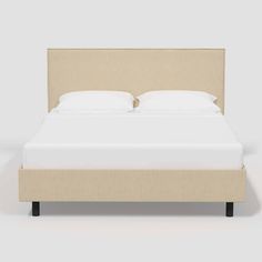 the headboard and foot board are made up in beige fabric with white sheets on it