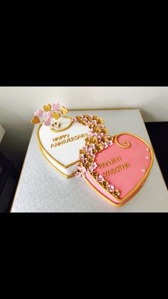 a heart shaped cake with pink and gold decorations