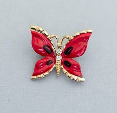 Vintage Red Butterfly Rhinestone Brooch CY1 Store Notes - This is the exact item you'll receive!  - USPS first class within 1 business day of purchase.  - Items are packaged in a jewelry box unless they are too big.  - Open to best offer - If you have any questions please ask! Thanks Tags Vintage Brooch, Vintage Broach, Broach, Brooch, Brooches, Grandma Brooch, Girls Brooch, Ladies Brooch, Fashion Brooch, Ladies Broach, Fashion Broach, Grandma Broach, Gift For Her, Costume Brooch, Costume Broach Red Enamel Pins For Gifts, Red Enamel Brooch Pin, Red Enamel Brooch, Red Enamel Pin Gift, Red Enamel Pin As Gift, Red Enamel Pin For Gift, Red Enamel Brooch Pin For Gift, Red Enamel Brooch Gift, Red Enamel Brooch Jewelry