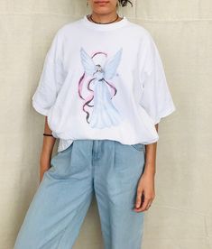 90's oversized Angel Tshirt 100% Cotton One Size Fits All Modeled on a Size Small Made in the USA 90s Style Oversized Short Sleeve T-shirt, Oversized Y2k T-shirt With Short Sleeves, 90s Inspired Oversized Crew Neck T-shirt, Oversized Crew Neck T-shirt Inspired By 90s, Oversized 90s Inspired Crew Neck T-shirt, Oversized 90s Inspired Streetwear T-shirt, Oversized 90s T-shirt With Crew Neck, Oversized 90s Crew Neck T-shirt, Angel Tshirt