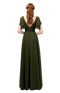 a woman in a green dress with her back to the camera