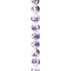 a purple and white beaded necklace with skulls on it