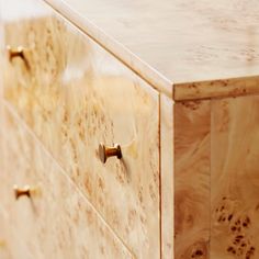 a wooden dresser with brass handles and knobs on it's doors is seen in this image