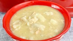 a red bowl filled with chicken and dumpling soup