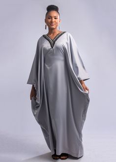 This super gorgeous kaftan has an added beaded embellished appliqué on the neckline. This dress is the perfect definition of a luxury kaftan. Has a belt inside that can be tight around the waist to give a nice snatch. Fun and easy to wear. Elegant V-neck Kaftan With Embroidered Neckline, Embellished V-neck Abaya For Eid, Elegant Embellished Maxi Length Thobe, Elegant Maxi Length Agbada For Eid, Evening Embellished Long Thobe, Elegant V-neck Thobe For Party, Evening Long Embellished Thobe, Elegant V-neck Party Thobe, Formal Long Embellished Kaftan