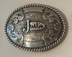 a silver belt buckle with the word justice printed on it's center and sides