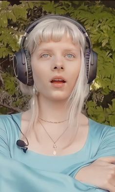 a woman with white hair wearing headphones