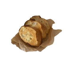 four pieces of bread sitting on top of brown paper bagged in wax paper with white background