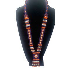 Colorful long seed bead Native American necklace with fun fringe in a striking pattern. This necklace says summer, beach, resort. Necklace measures 16 inches, pendant measures 4 1/2 inches from top to the bottom of the fringe. No clasp, just slip over your head. Striking with a swingy beach dress or a jean jacket. Shop more necklaces here: https://www.etsy.com/shop/BoutiqueByMaryam?section_id=21694658 Be sure to visit the rest of my shop here: https://www.etsy.com/shop/boutiquebymaryam Traditional Adjustable Beaded Fringe Necklaces, Traditional Adjustable Beaded Fringe Necklace, Artisan Hand-strung Lariat Beaded Necklaces, Traditional Beaded Lariat Jewelry, Southwestern Beaded Necklace With Dangling Beads For Festivals, Artisan Beaded Fringe Necklaces For Festivals, Southwestern Style Festival Beads With Dangling Details, Artisan Necklace With Beaded Fringe For Festivals, Multicolor Beaded Lariat Necklace With Round Beads