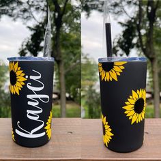 two tumblers with sunflowers painted on them, one is black and the other is yellow