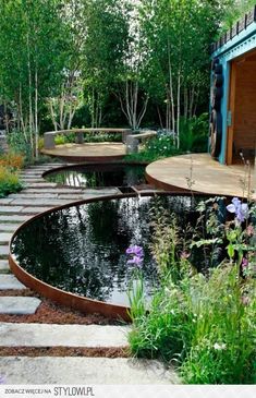 an outdoor garden with water and stepping stones