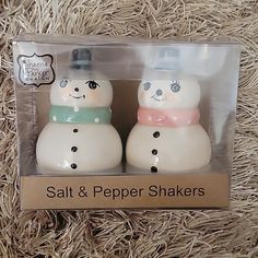 two salt and pepper shakers with snowmen on them in a package for sale