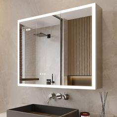 a bathroom sink sitting under a mirror in front of a wall mounted faucet